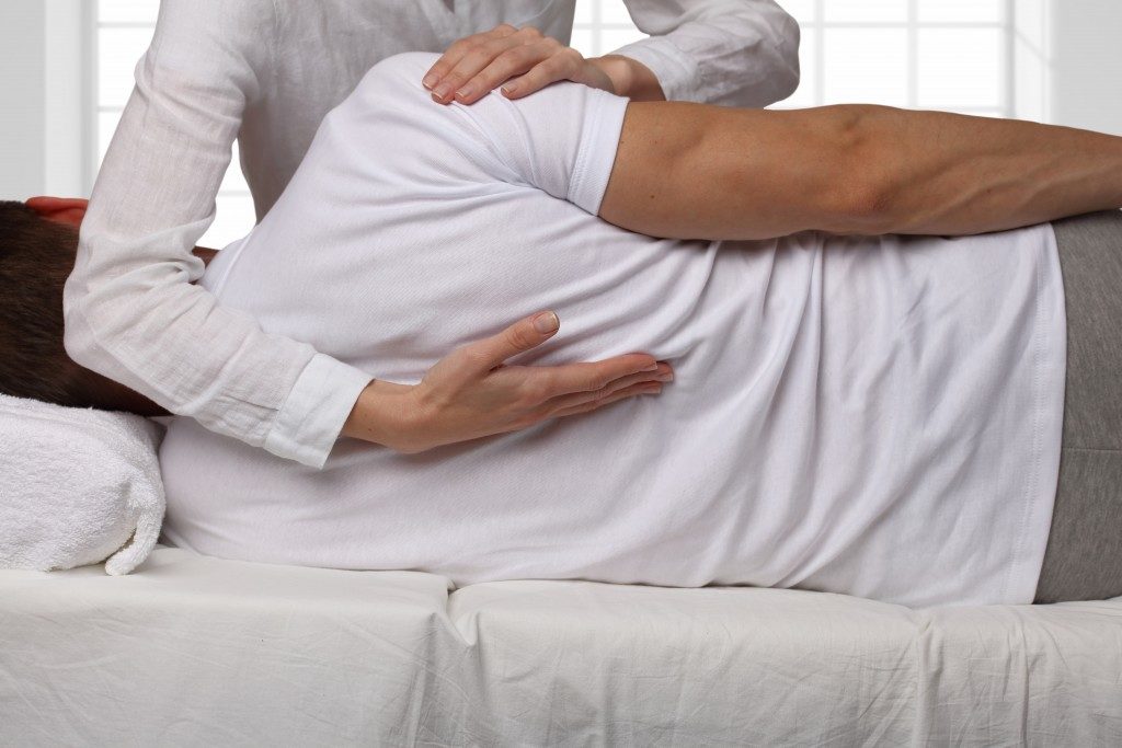 Man undergoing a back chiropractic treatment