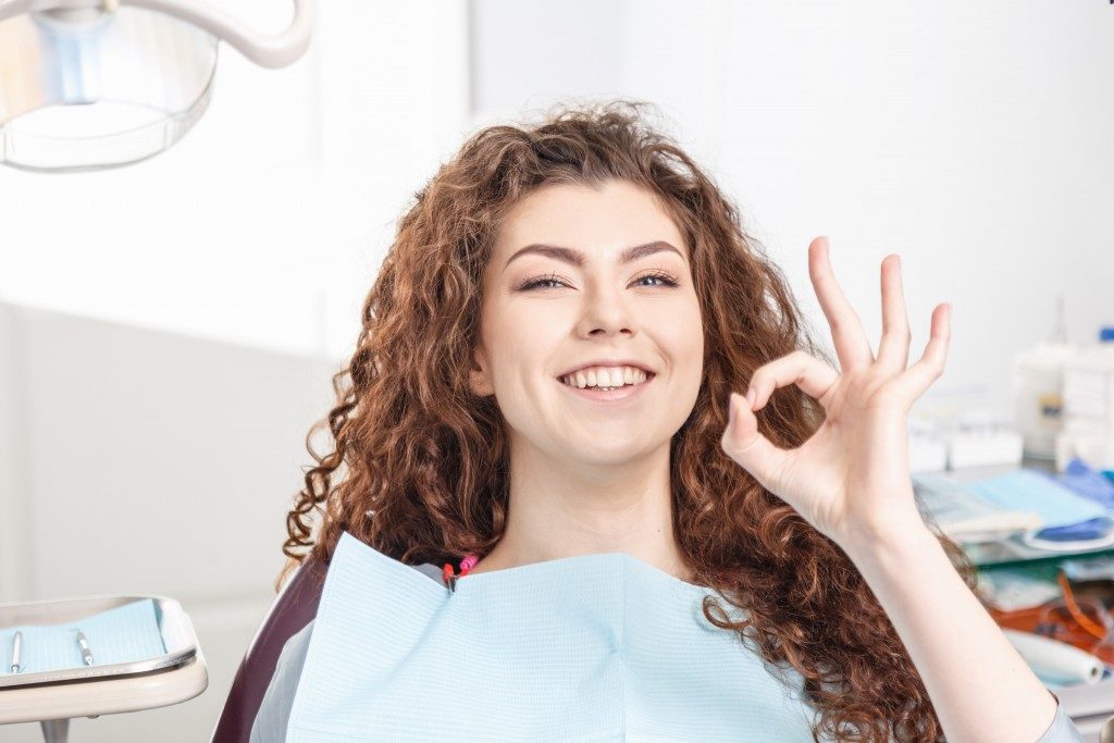 Woman just finished having teeth clleaned in a dental clinic