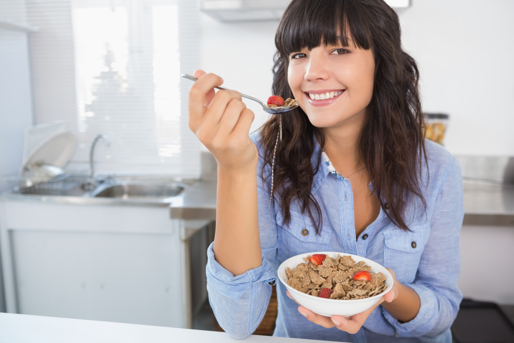 woman eating a hearty and healthy meal in a bowl