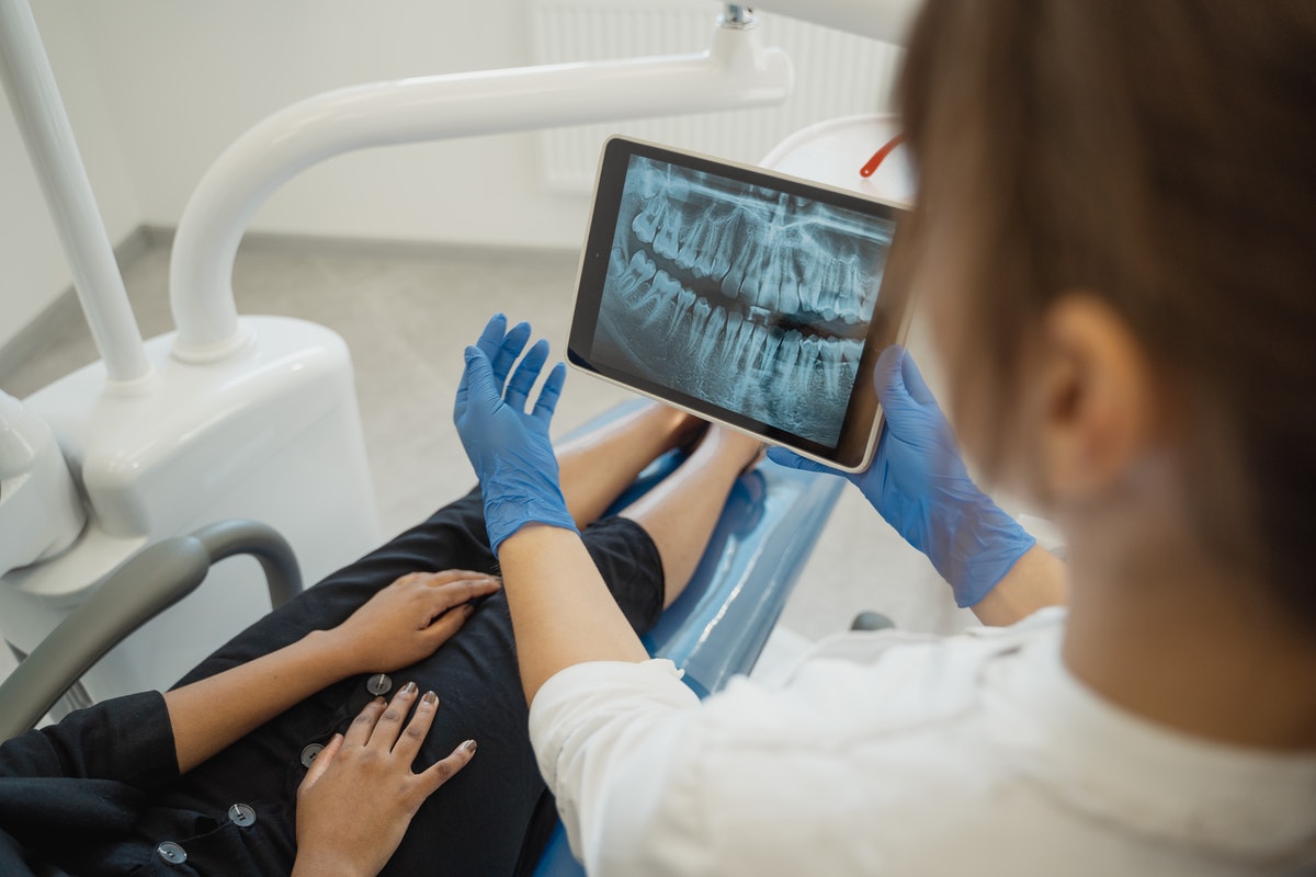 woman dentist checking up a patient