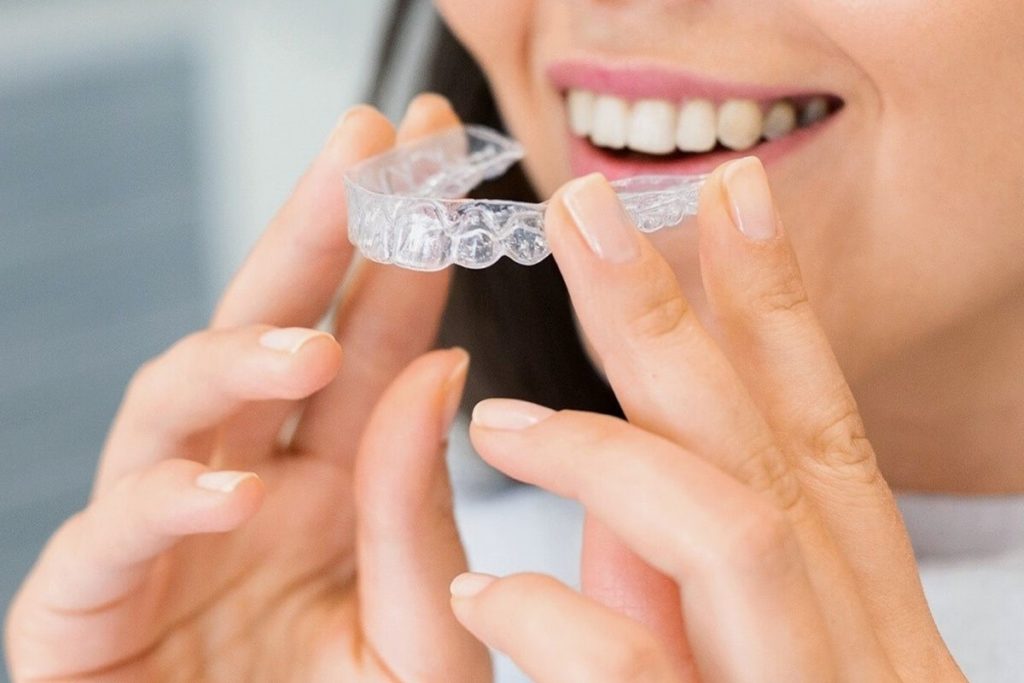 Woman holding aligners