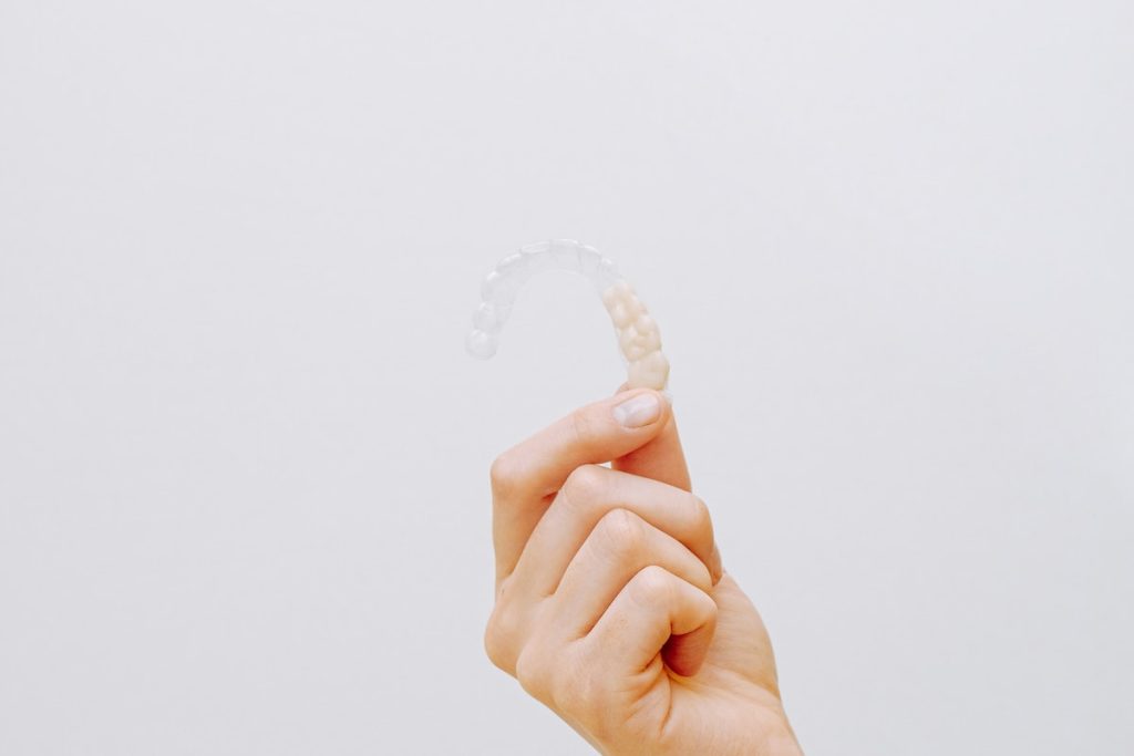 Person Holding Clear Aligner