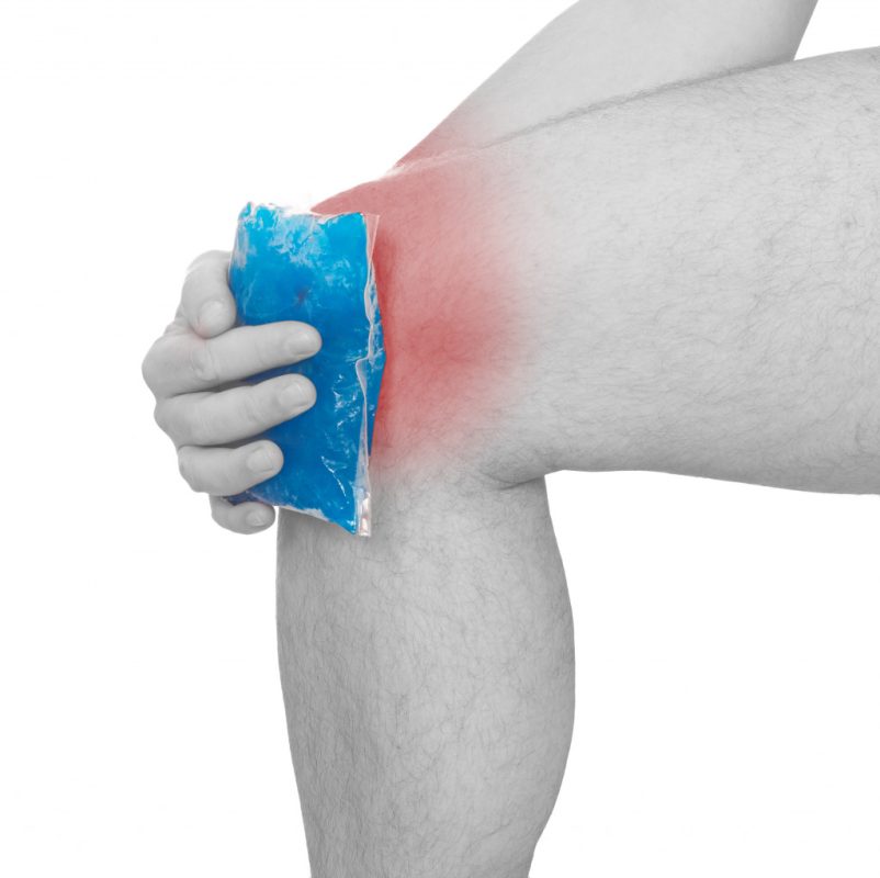 Putting an ice gel pack on an injured knee