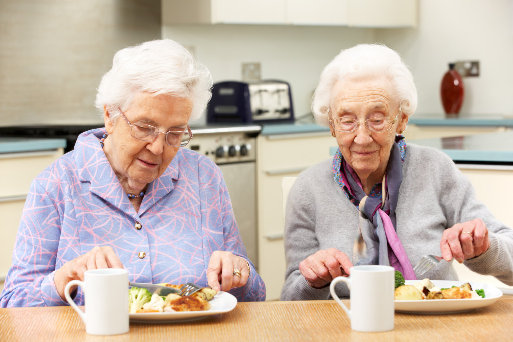 Two senior women eating together