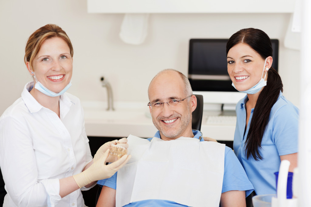 a dentist holding a 3d-printed denture