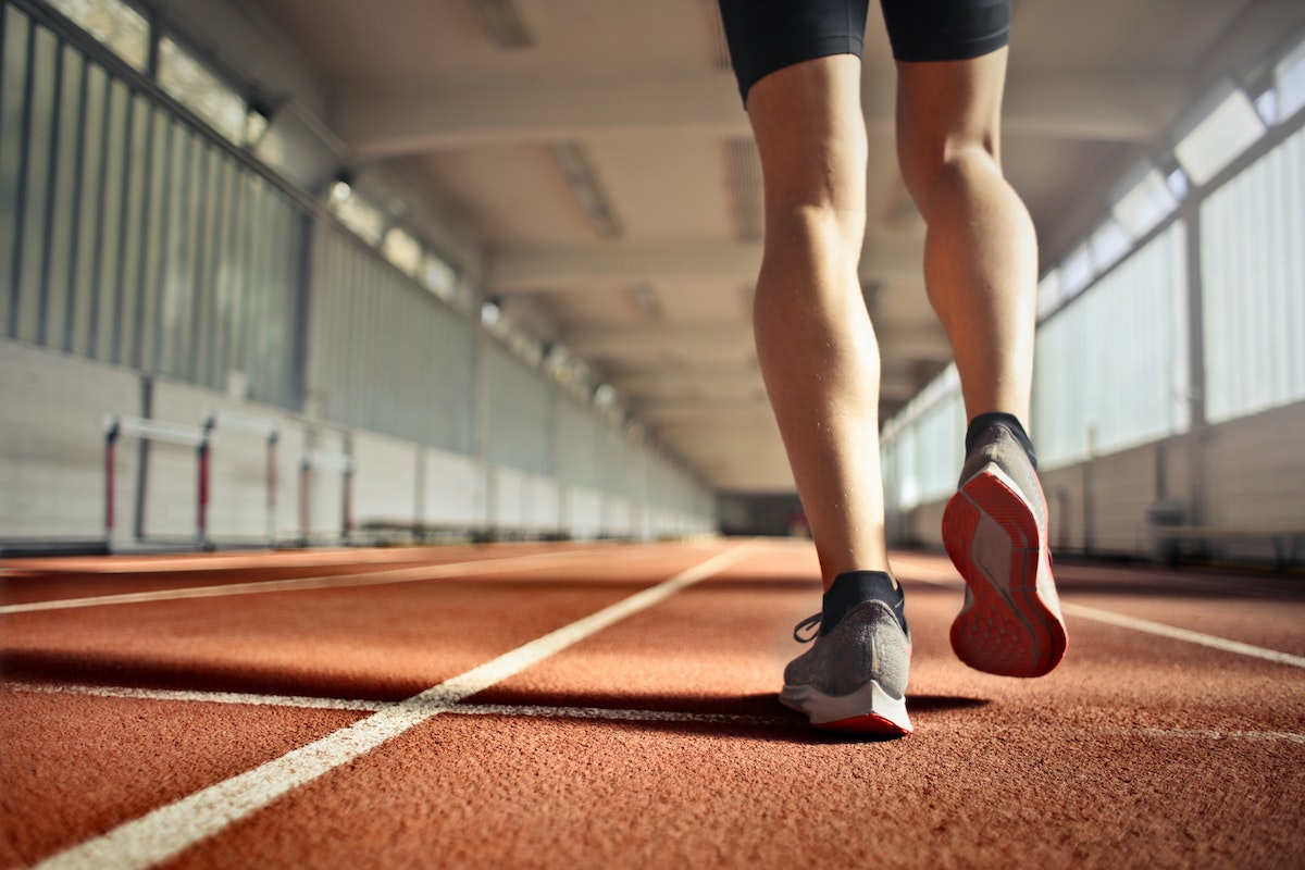 Fit athlete during training on running track