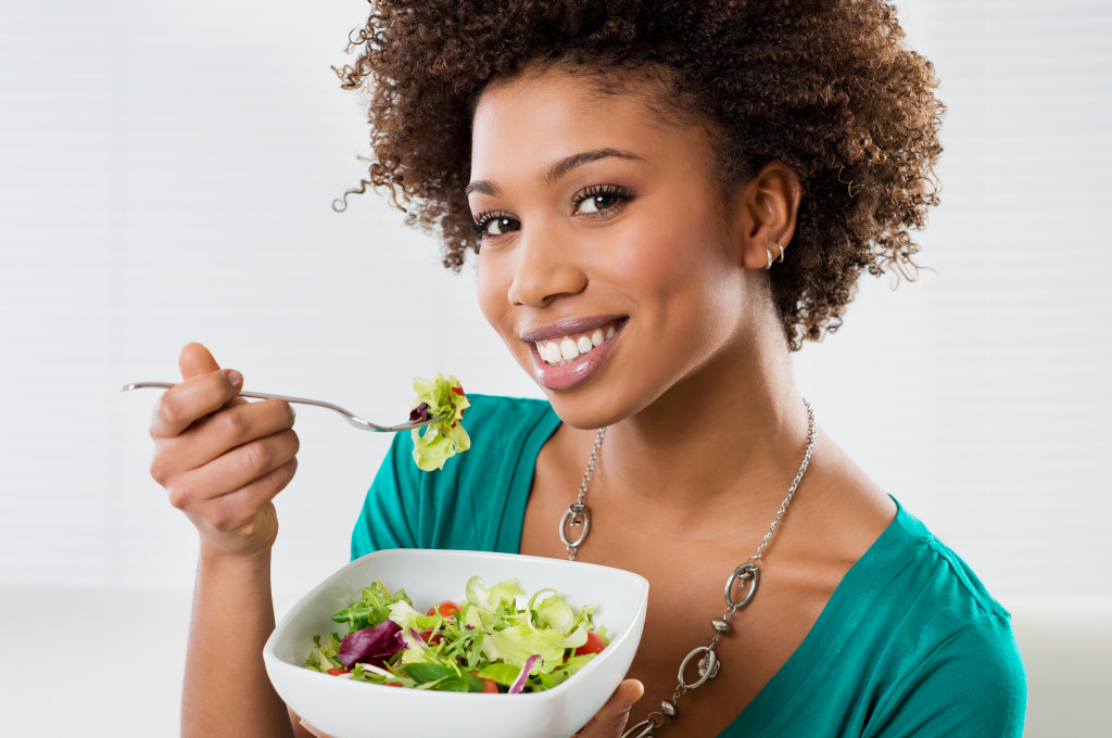 A woman eating a healthy salad