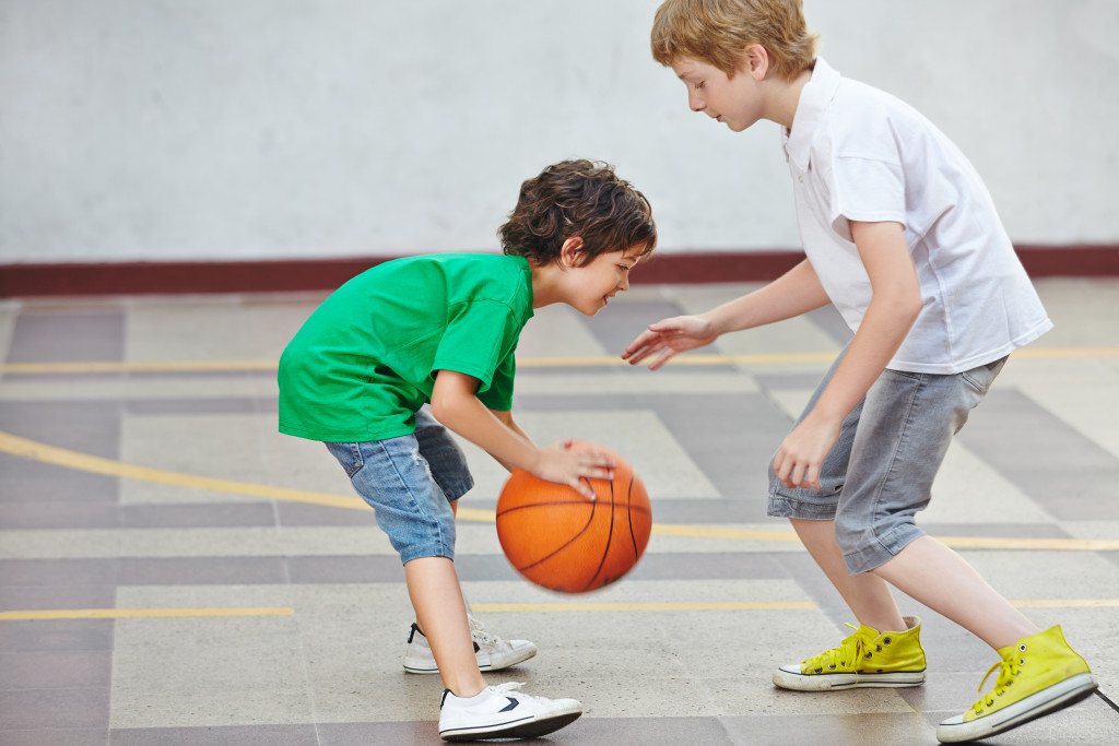 two young boys playing basketball