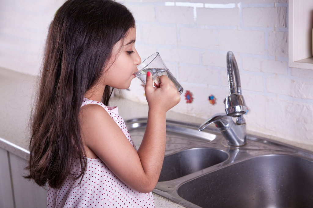 a female kid drinking water