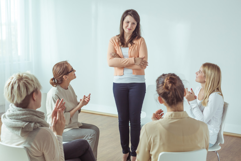 A woman talking with a support group