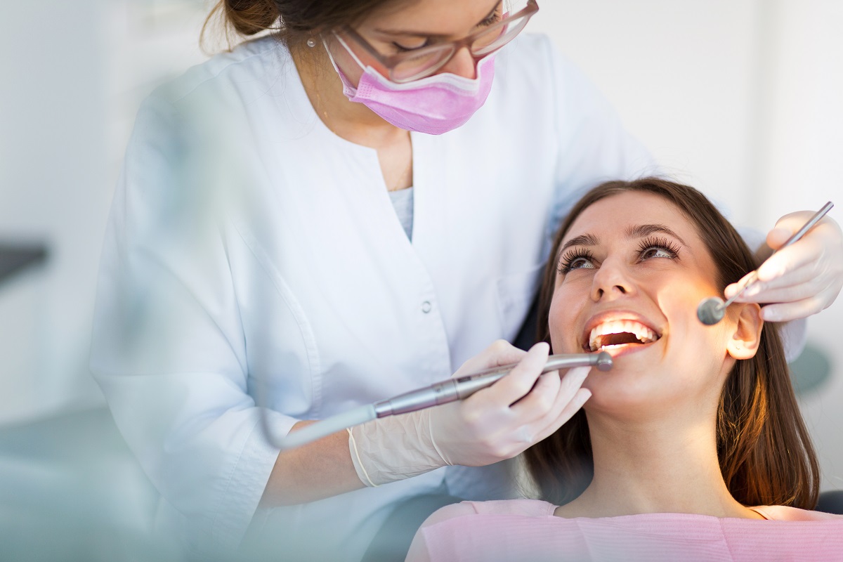 a dentist checking patient's teeth